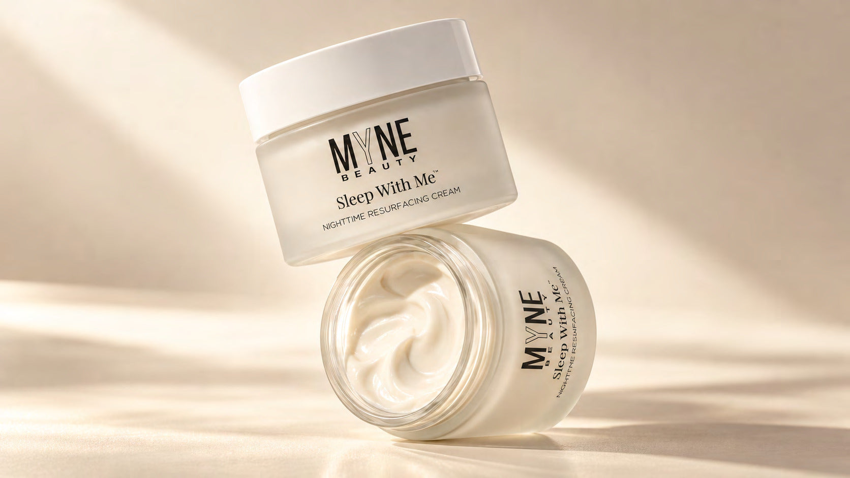 Sleep With Me nighttime resurfacing cream jars in warm natural light, t4